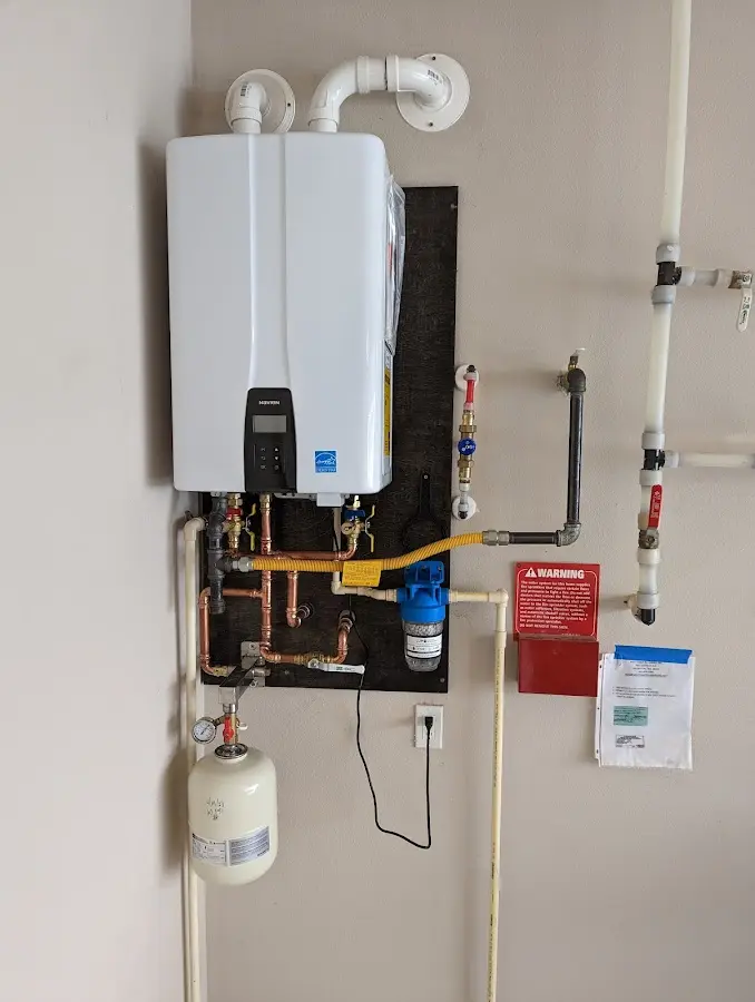 Professional plumber installing copper piping in a New Paltz home